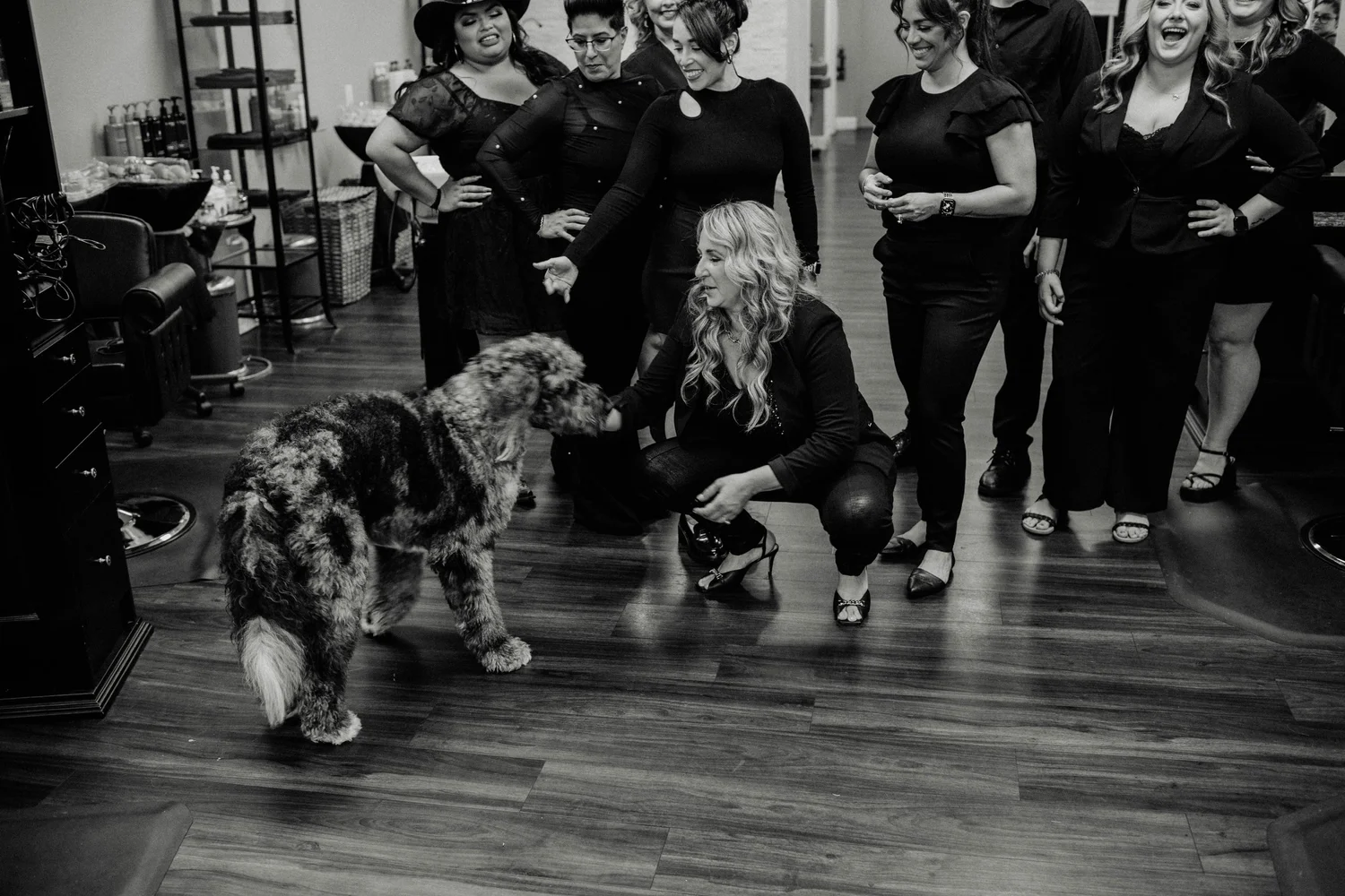 Kim Fanucci with the salon team and a dog at Austin James Hair Studio